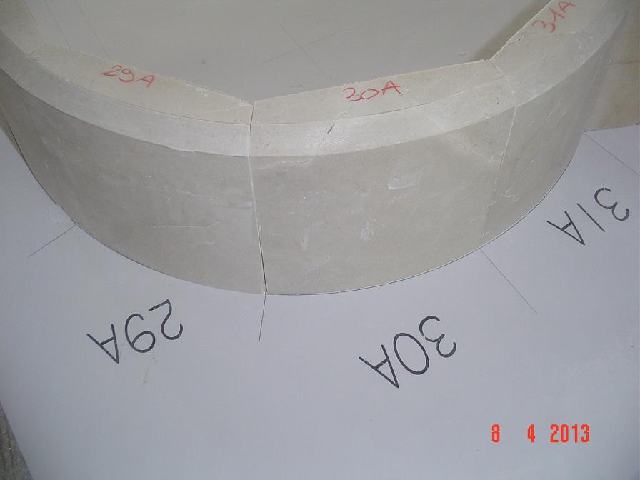 Solid pieces of crema marfil marble. Two curved pieces of the fountain under test.