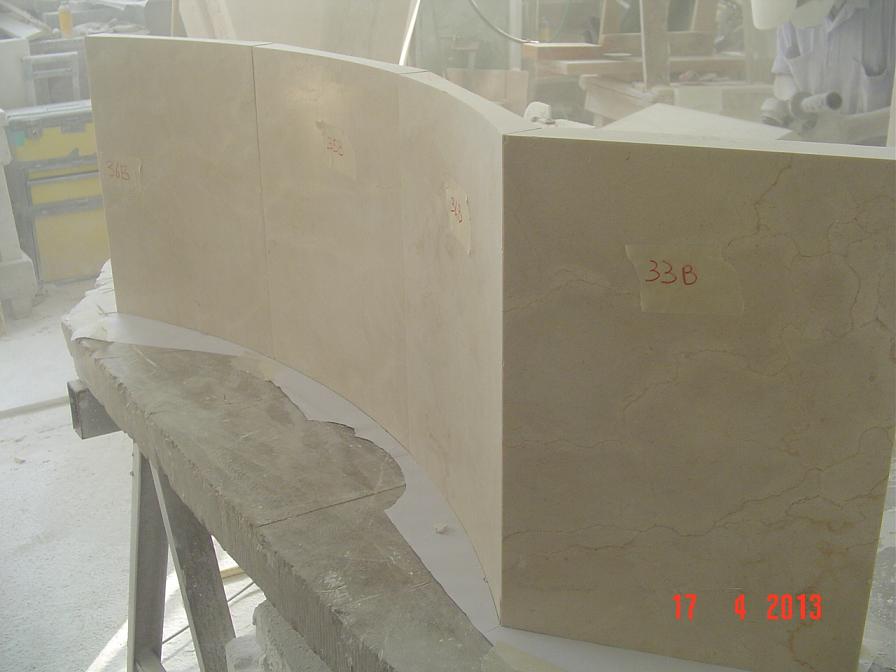 Solid pieces of crema marfil marble. Two curved pieces of the fountain under test.