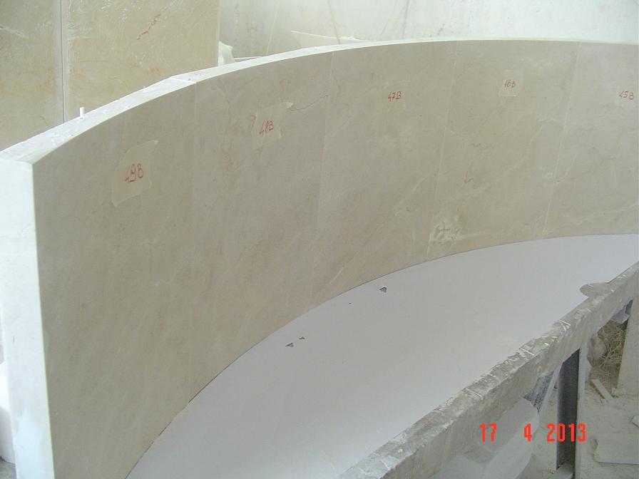 Solid pieces of crema marfil marble. Curved pieces of the fountain under test.