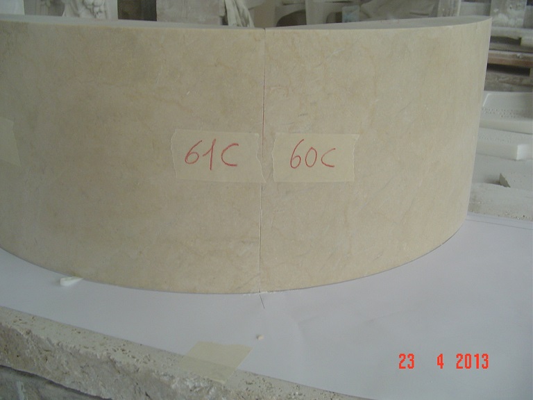 Solid pieces of crema marfil marble. Two curved pieces of the fountain under test.