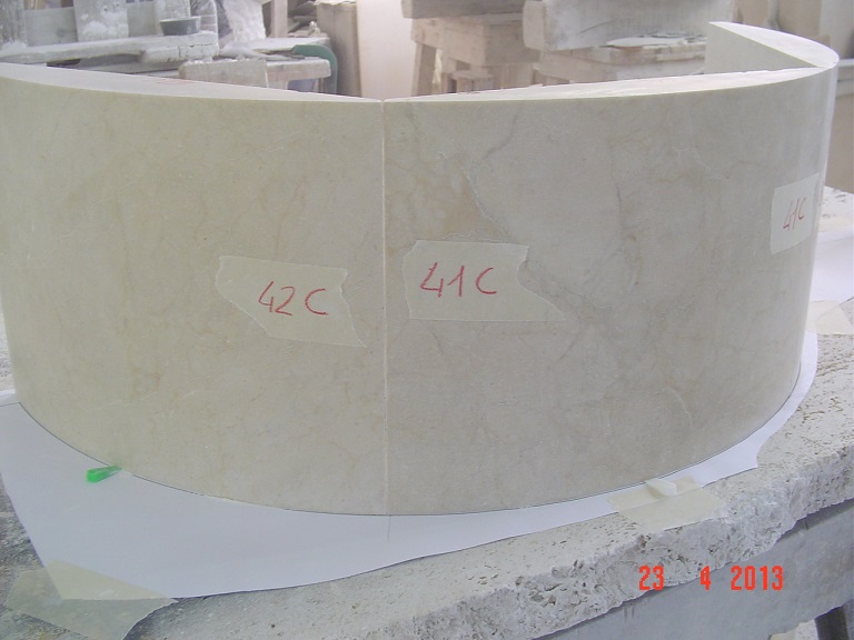 Solid pieces of crema marfil marble. Two curved pieces of the fountain under test.